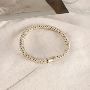 Detailed view of stylish braided hair tie with metal tube decor for daily ponytail styling.