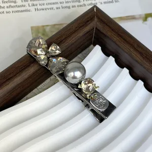 Exquisite silver crystal pearl hair clip detail view sparkling rhinestone side hair accessory.