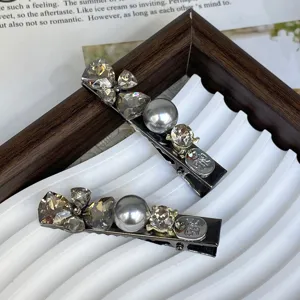 Detailed shot of silver rhinestone pearl hair clips, elegant side clip hair accessory.