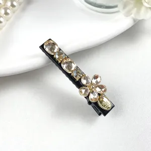 Detail view of elegant crystal rhinestone hair clip featuring sparkling champagne stones for women.