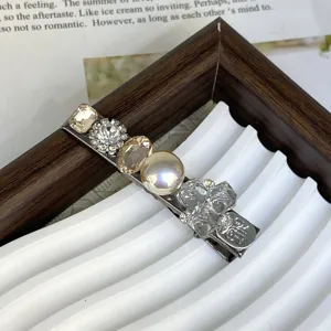 Crystal pearl hair clip detail shot, showing sparkling rhinestones and silver metal base.