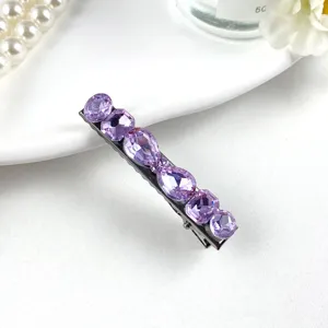 Exquisite purple crystal hair clip detail showcasing sparkling cut stones on metal base.