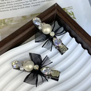 Exquisite black bow pearl hair clip detail, featuring sparkling rhinestones and elegant design.
