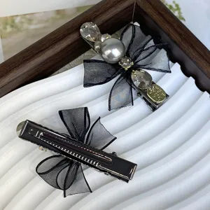 Detailed view of black mesh bow rhinestone pearl hair clips, sweet side clip for women.