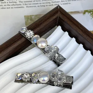 Silver hair clip set featuring sparkling crystal rhinestones and elegant pearls for chic styling.