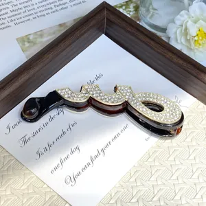 Rhinestone paperclip banana clip hair accessory detail shot, elegant vertical ponytail holder.