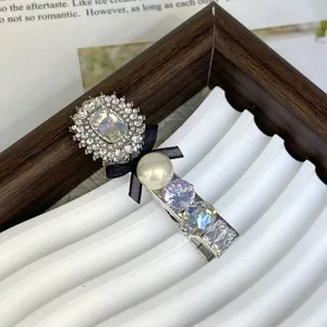 Elegant silver rhinestone hair clip with crystal pearl and black bow for daily wear.