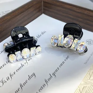 Small hair claw clips set with sparkling crystals, elegant side hair accessories for women.
