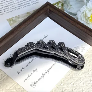 Detailed view of a luxury black rhinestone banana clip, modern geometric design for chic ponytail.