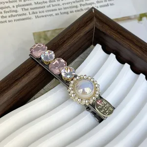 Crystal hair clip detail shot showing pink and clear rhinestones with metal accent.