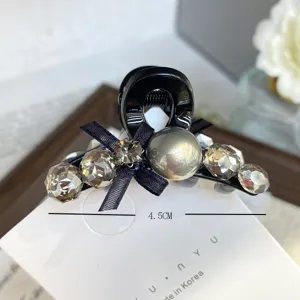 Small hair claw clip with black bow and sparkling rhinestones for women daily cute hair styling.