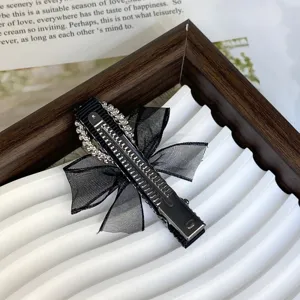 Detailed view of black bow rhinestone pearl hair clip, exquisite side clip for sweet style.