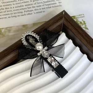 Exquisite black bow hair clip with sparkling rhinestones and elegant pearl for sweet daily wear.