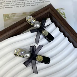 Chic black bow hair clip with sparkling rhinestones and elegant pearl for women and girls daily wear.