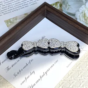 Alloy rhinestone hair clip detail view, elegant crystal bow design for charming ponytail styles.