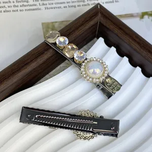 Silver hair clip with pearls and rhinestones, elegant side hairpin for women styling.