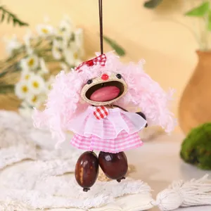 Handcrafted nut shell doll pendant, close-up showing cute pink fluffy hair and checkered dress.