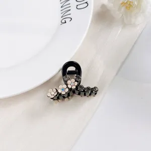 Pince à cheveux noire avec fleurs et strass, petit accessoire élégant pour coiffure.