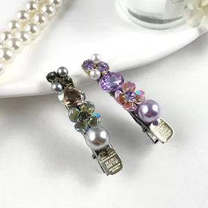 Detailed shot of luxury rhinestone pearl hair clips with colorful floral accents for women.
