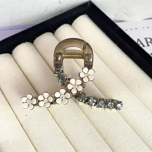 Elegant camellia hair claw clip with sparkling rhinestones, perfect for half up hairstyles.