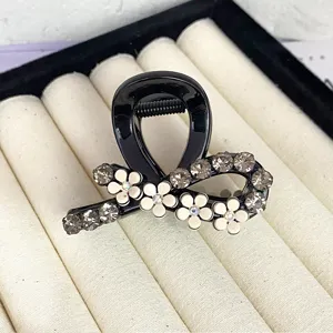 Elegant black hair claw clip with white flower and crystal rhinestones, chic small shark clip for women.