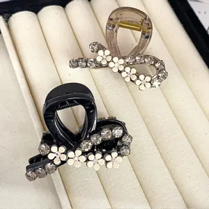 Elegant rhinestone camellia hair claw clips, stylish small shark clips for daily use.