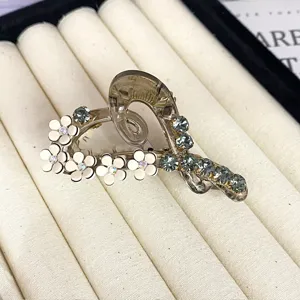 Elegant camellia hair claw clip with rhinestones, stylish heart-shaped hair accessory for women.