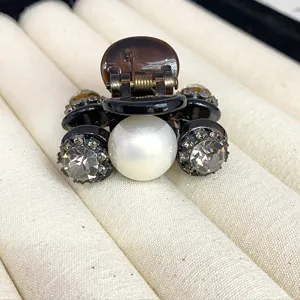 Small hair claw clip with faux pearl and sparkling rhinestones for elegant half-up hairstyles.