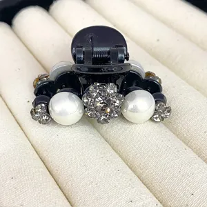 Black hair claw clip with crystal flower and faux pearls, compact size for half-up hair styles.