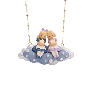 Detailed close-up of the fairy tale doll cloud necklace, delicate gold beaded chain pendant.