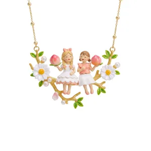 Fairy tale doll necklace detail featuring cute little girls holding peaches on a gold branch.