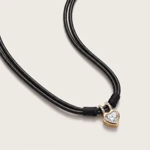 Elegant gold heart cubic zirconia pendant necklace featuring double black braided rope cords.