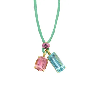 Detailed close-up of a vibrant gemstone pendant necklace featuring a green cord and stones.