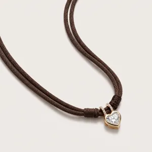 Heart zircon pendant necklace with double brown braided ropes, elegant and vintage style detail.