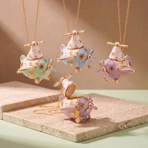Cute openable airplane pendant necklace featuring sun moon and star enamel details, delicate gold chain.