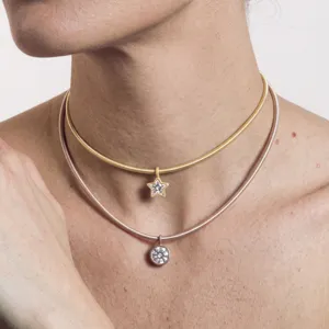 Close-up van de dubbellaagse choker ketting met ster en ronde zirkonia hangers van roestvrij staal.