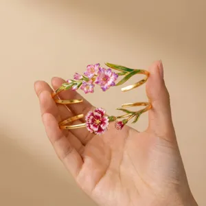 Detailed close-up of enamel floral cuff bracelets highlighting delicate floral design.