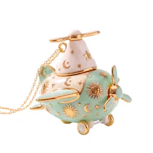 Cute enamel airplane necklace with sun and moon celestial charms, openable gold pendant jewelry.