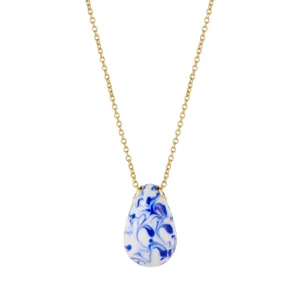 Gros plan du collier pendentif en porcelaine bleue et blanche en forme de goutte et chaîne dorée.