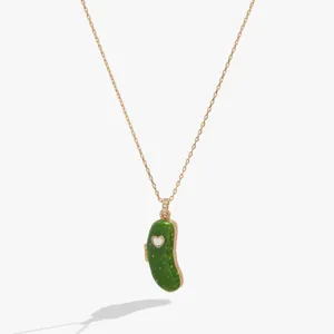 Detail view of the whimsical pickle pendant necklace, featuring enamel green finish and chain.