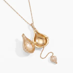 Rose gold openable pod pendant necklace, intricate seed charm detail, close-up shot.