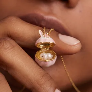 Close-up detail shot of the cute bunny locket necklace with gold plating and enamel finish.