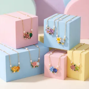 Chic birth flower necklace set with colorful enamel floral charms and delicate pearl chains.