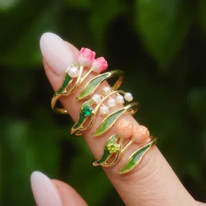 Detailed view of fashionable enamel floral rings featuring tulip and lily of the valley designs.