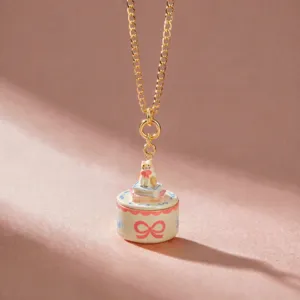 Close-up detail of the cute cat on books pendant necklace, featuring fine enamel and gold chain.