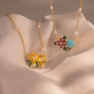 Exquisite floral enamel pendant necklace with pearls and gold-tone chain, elegant detail view.