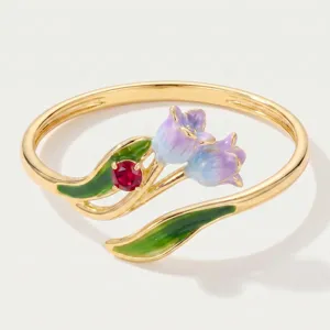 Exquisite gold-plated enamel tulip flower detail shot featuring purple blossoms and red crystal.