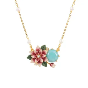 Detail view of chic floral pendant necklace with enamel pink flowers and pearls on gold chain.