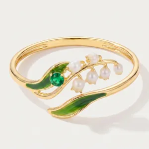 Gold-plated lily of the valley ring with green enamel leaves, pearls and green gemstone.