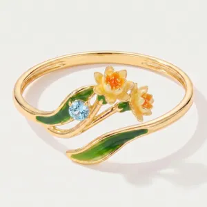 Exquisite gold-plated open ring featuring enamel floral and sparkling blue crystal details.